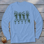 A light blue long-sleeve t-shirt featuring a green graphic of four mason jars filled with wildflowers on a wooden shelf.