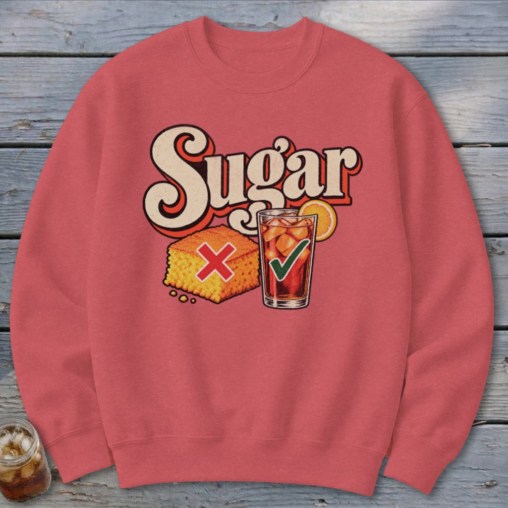 A red crewneck sweatshirt with the word Sugar printed above illustrations of cornbread with a red X and iced tea with a green checkmark.