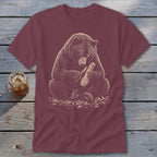 Bear carving wood with a knife, illustration on a maroon t-shirt.