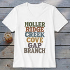 A white V-neck t-shirt with multi-colored stacked text reading HOLLER RIDGE CREEK COVE GAP BRANCH.