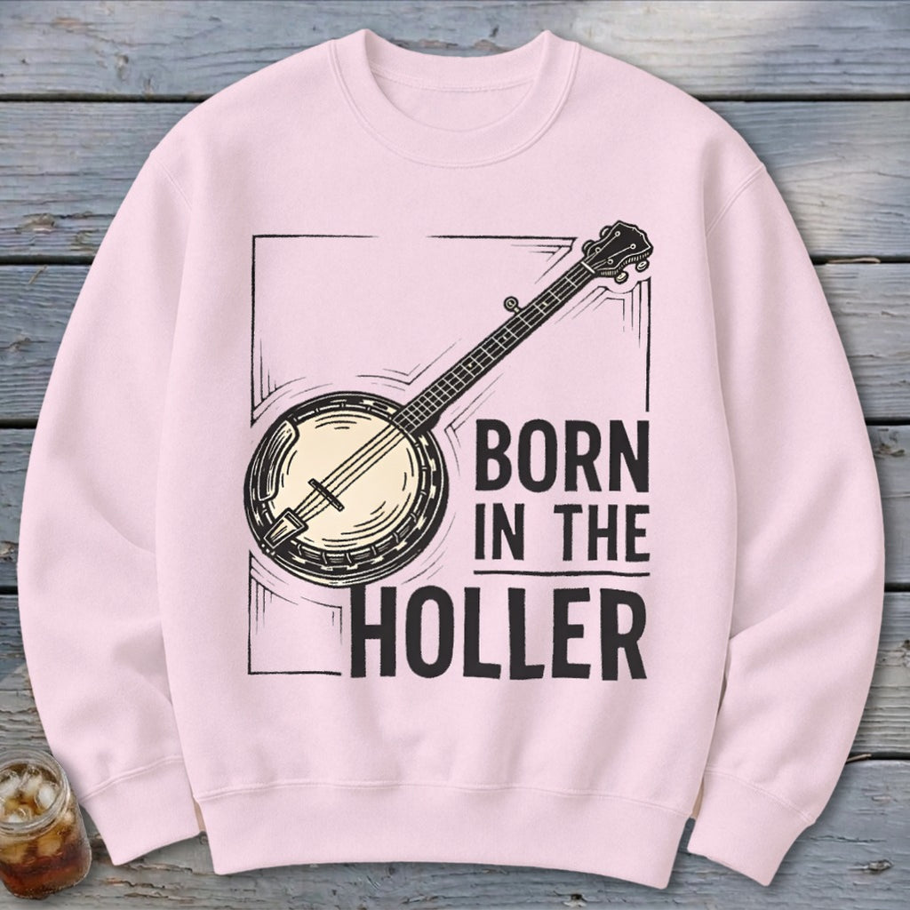 Pink crewneck sweatshirt with a banjo graphic and text "BORN IN THE HOLLER".