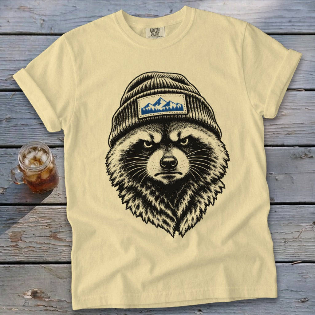 T-shirt with black and white illustration of a raccoon wearing a beanie with mountains.