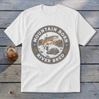 White t-shirt with circular "Mountain Born River Bred" graphic featuring a jumping trout.