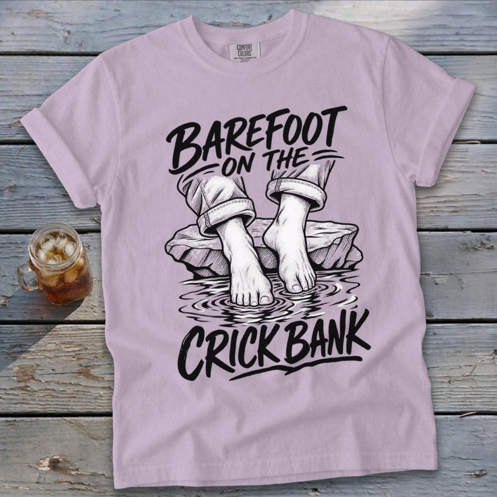 Light purple t-shirt with "BAREFOOT ON THE CRICK BANK" text and illustration.