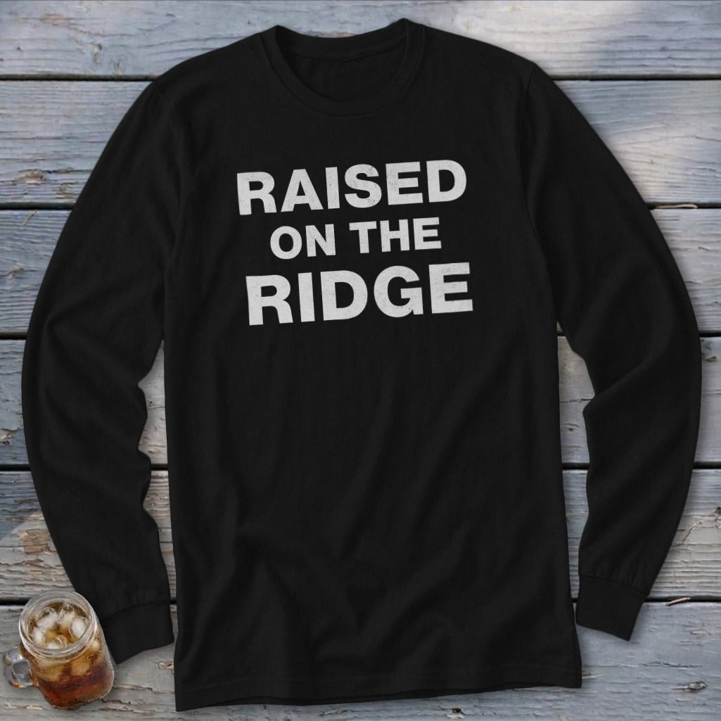 Black long-sleeve shirt with white text reading "RAISED ON THE RIDGE".