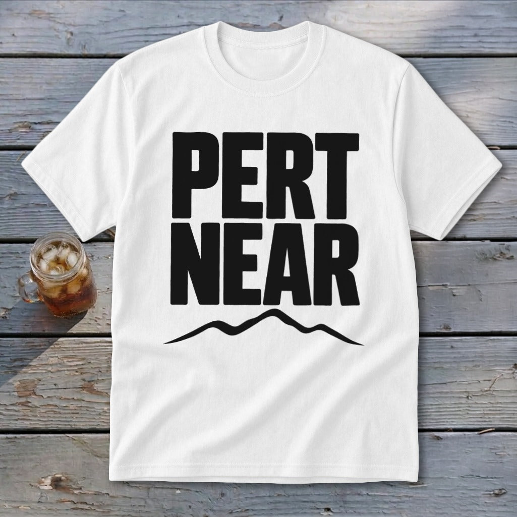 A white t-shirt featuring the text "PERT NEAR" in bold black font above a mountain silhouette.