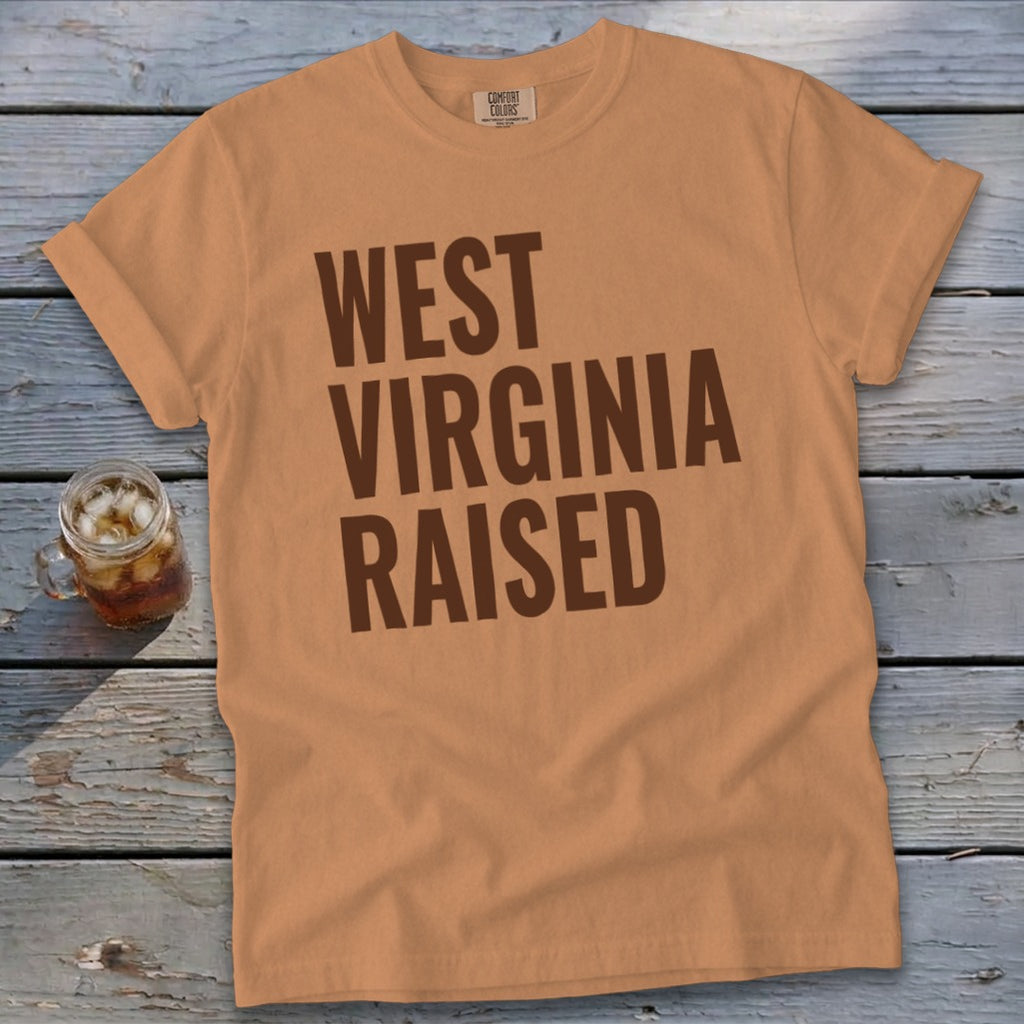 Peach t-shirt with brown text "WEST VIRGINIA RAISED".