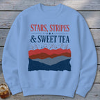 Light blue crewneck sweatshirt featuring the red, white, and blue graphic text Stars, Stripes, and Sweet Tea.