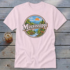 Pink t-shirt with circular graphic featuring "Mississippi" text, river, deer, and sunset landscape.