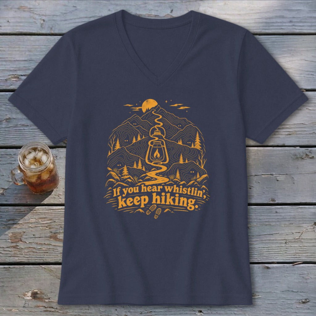 Navy v-neck t-shirt with orange mountain graphic and text "If you hear whistling, keep hiking."