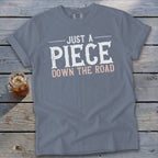 Gray t-shirt with "JUST A PIECE DOWN THE ROAD" text.
