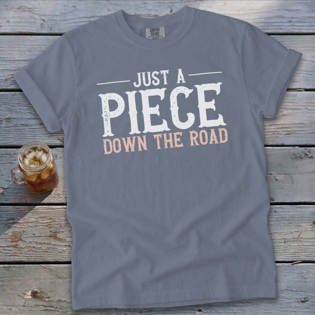 Gray t-shirt with "JUST A PIECE DOWN THE ROAD" text.