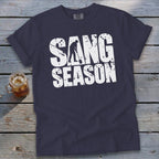 Dark blue t-shirt featuring distressed white text reading SANG SEASON with a silhouetted digger.