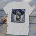 White t-shirt with a dark blue graphic of fireflies in a jar under a starry night sky.