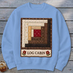 Light blue sweatshirt with a quilted log cabin block and "LOG CABIN" text.