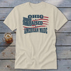 Cream-colored crewneck t-shirt featuring a distressed American flag graphic with the text Ohio Raised American Made.