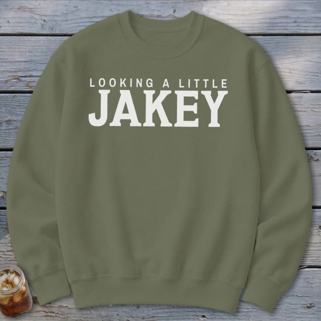 Olive green sweatshirt with white text "LOOKING A LITTLE JAKEY"