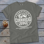 Gray t-shirt featuring a circular graphic with text reading Certified Cornbread Judge and an illustration of cornbread.