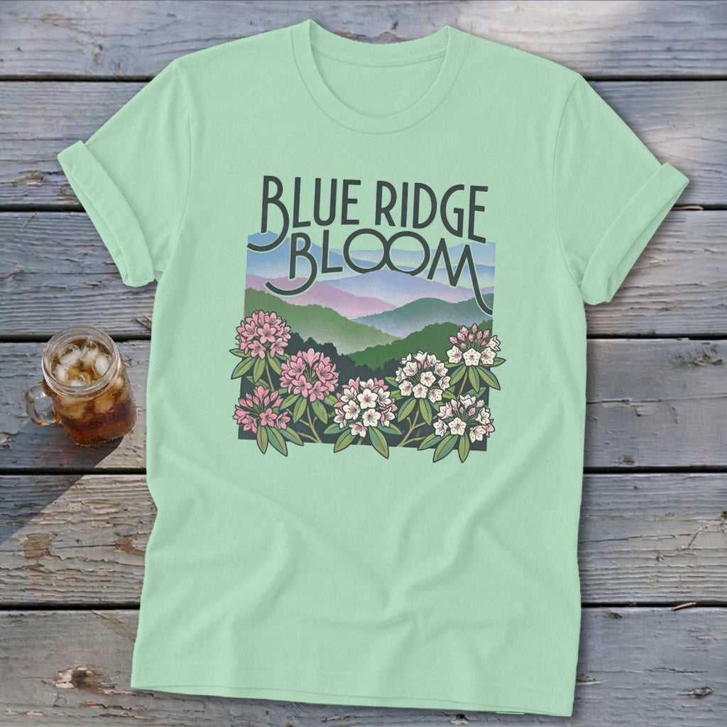 Light green t-shirt with "Blue Ridge Bloom" text and mountain floral graphic.