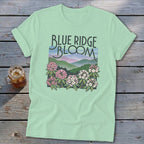 Light green t-shirt with "Blue Ridge Bloom" text and mountain floral graphic.
