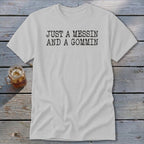 A light gray t-shirt with the text JUST A MESSIN AND A GOMMIN printed in black.