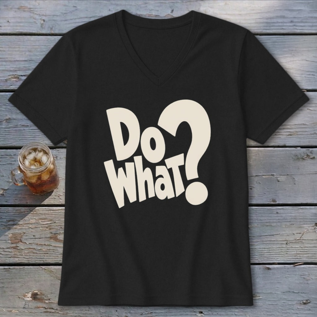 A black V-neck t-shirt with beige text reading Do What? laid on a wooden surface.
