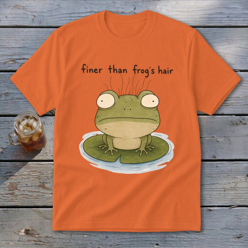 An orange t-shirt featuring a cartoon frog on a lily pad with the text finer than frog's hair.