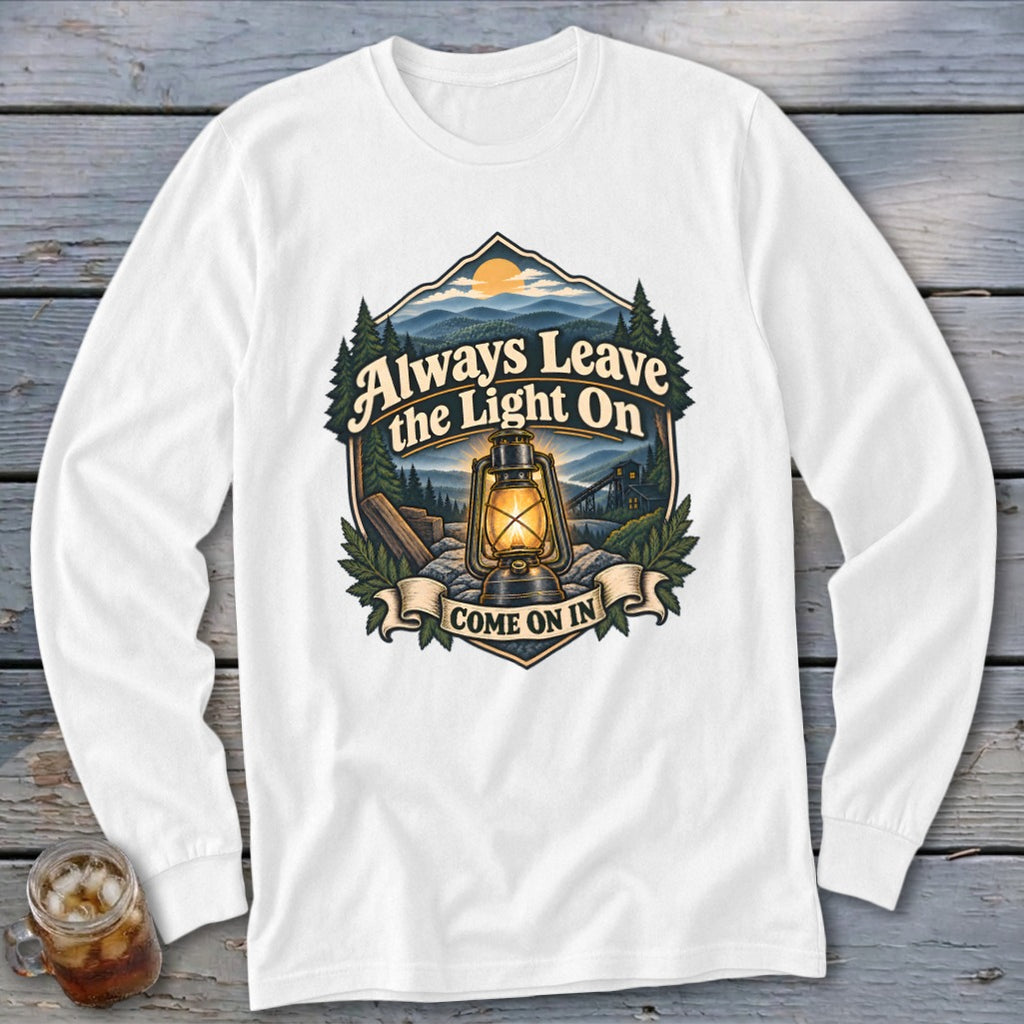 White long sleeve shirt with a graphic of a lantern, mountains, and the text "Always Leave the Light On Come On In."