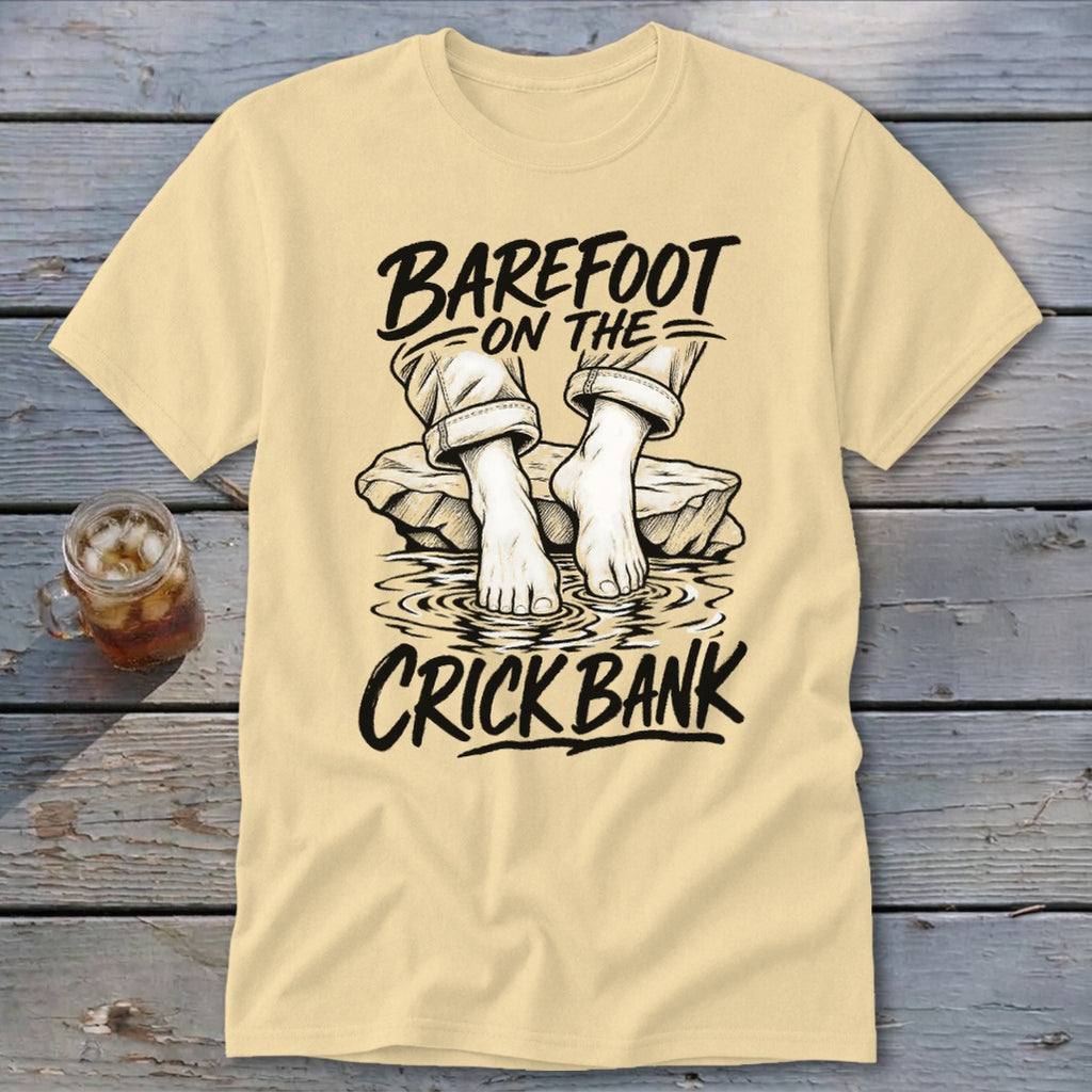 Cream t-shirt with graphic: "Barefoot on the Crick Bank" and feet in water.