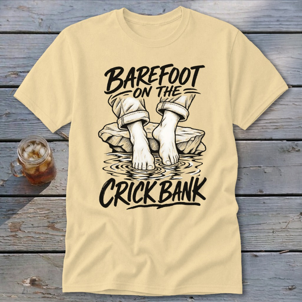 Cream t-shirt with graphic: "Barefoot on the Crick Bank" and feet in water.