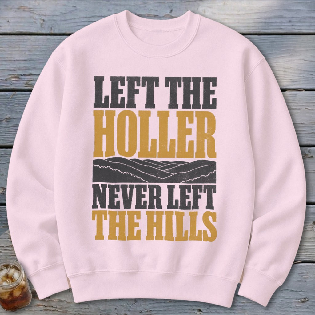 Pink sweatshirt with "Left the Holler Never Left the Hills" text and mountain graphic.