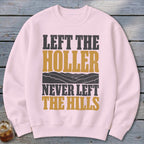 Pink sweatshirt with "Left the Holler Never Left the Hills" text and mountain graphic.
