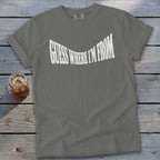 Grey t-shirt with white text "GUESS WHERE I'M FROM" in a curved font.