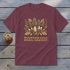 Maroon t-shirt with illustration of morel mushrooms and text "MOUNTAIN GOLD MOREL HARVEST".