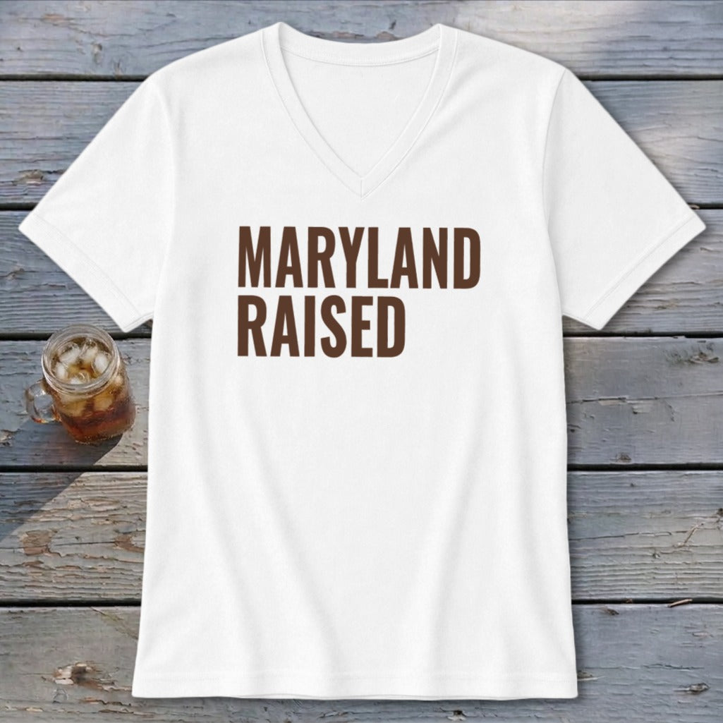 White v-neck t-shirt with brown text "MARYLAND RAISED" and a glass of iced tea.