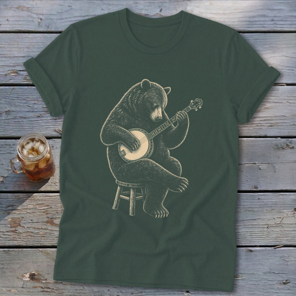 Bear playing a banjo on a stool, graphic on a dark green t-shirt.