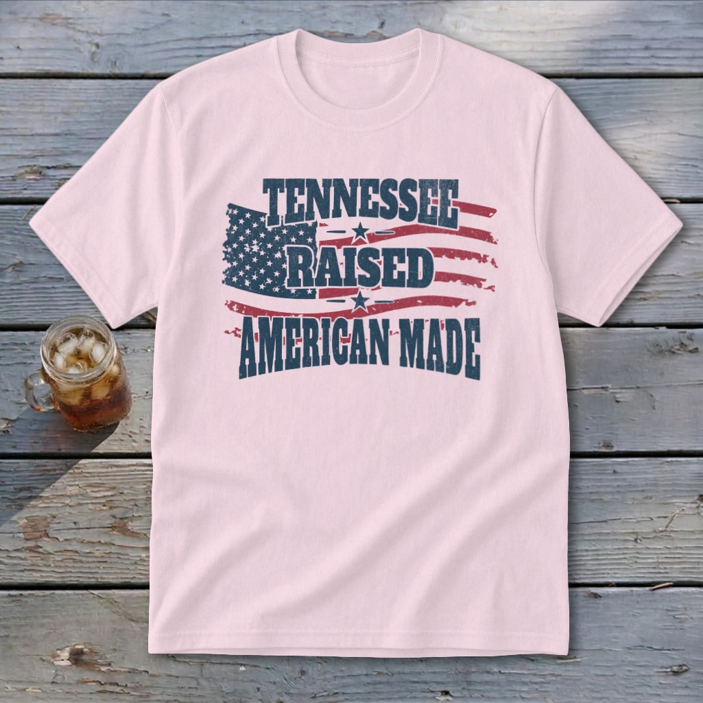 Pink t-shirt with distressed American flag and text: Tennessee Raised American Made.