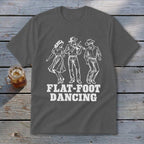 Grey t-shirt with white graphic of three people dancing, one playing violin, text reads "FLAT-FOOT DANCING".