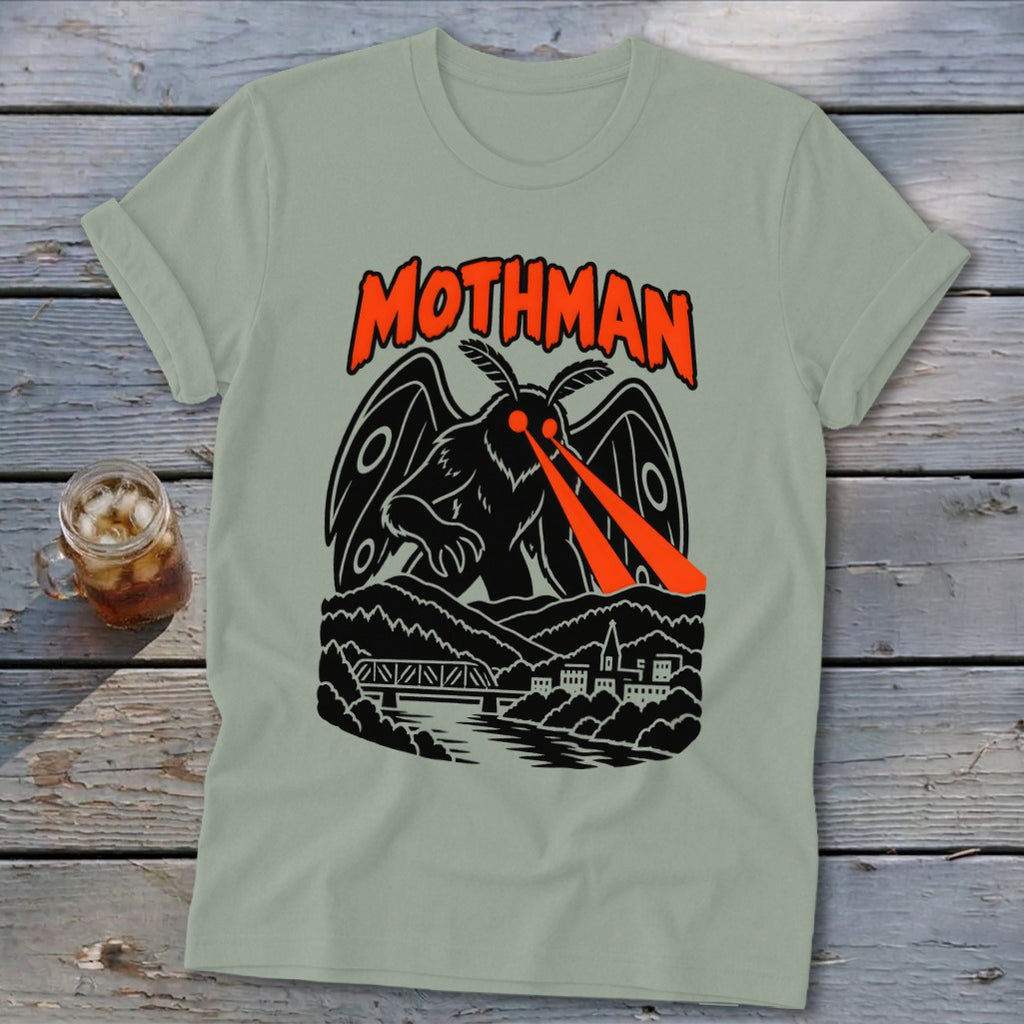 Mothman graphic on a light green t-shirt with a bridge and town.