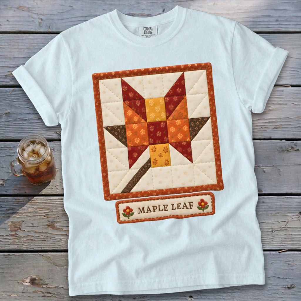 White t-shirt with a quilted maple leaf design and text "MAPLE LEAF".