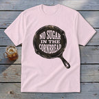 Pink t-shirt with graphic of cast iron skillet and text "No Sugar In The Cornbread".