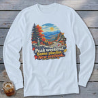 Long sleeve shirt with autumn mountain scene and text "Peak weekend. Same playlist. New overlook."