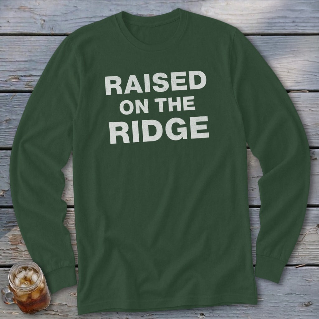 Long-sleeved green shirt with white text "RAISED ON THE RIDGE".