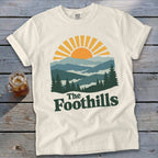 Cream t-shirt with "The Foothills" text and a mountain landscape graphic.