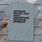 Light blue t-shirt with black text reading "ANYMORE PEOPLE JUST DON'T UNDERSTAND MOUNTAIN GRAMMAR".
