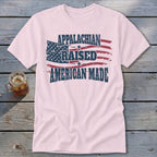 Pink t-shirt with distressed American flag graphic and text: Appalachian Raised American Made.