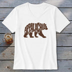 A white V-neck t-shirt featuring a brown bear graphic filled with the word Appalachia.