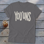 Grey t-shirt with "YOU'UNS" in off-white text and a glass of iced tea.