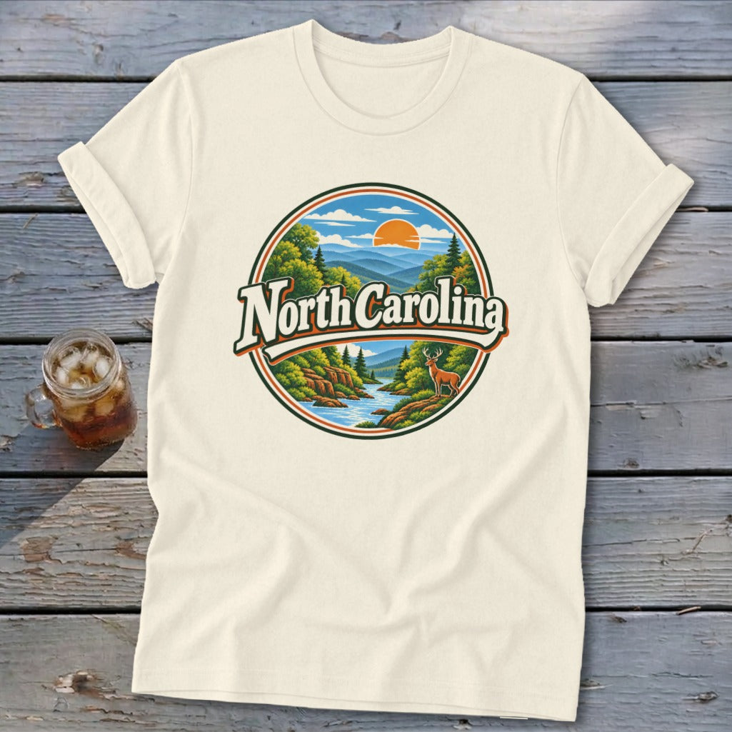 Cream t-shirt featuring a circular vintage graphic of mountains, river, deer, and "North Carolina" text.
