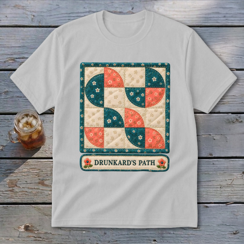 White t-shirt featuring a Drunkard's Path quilt block design with text.